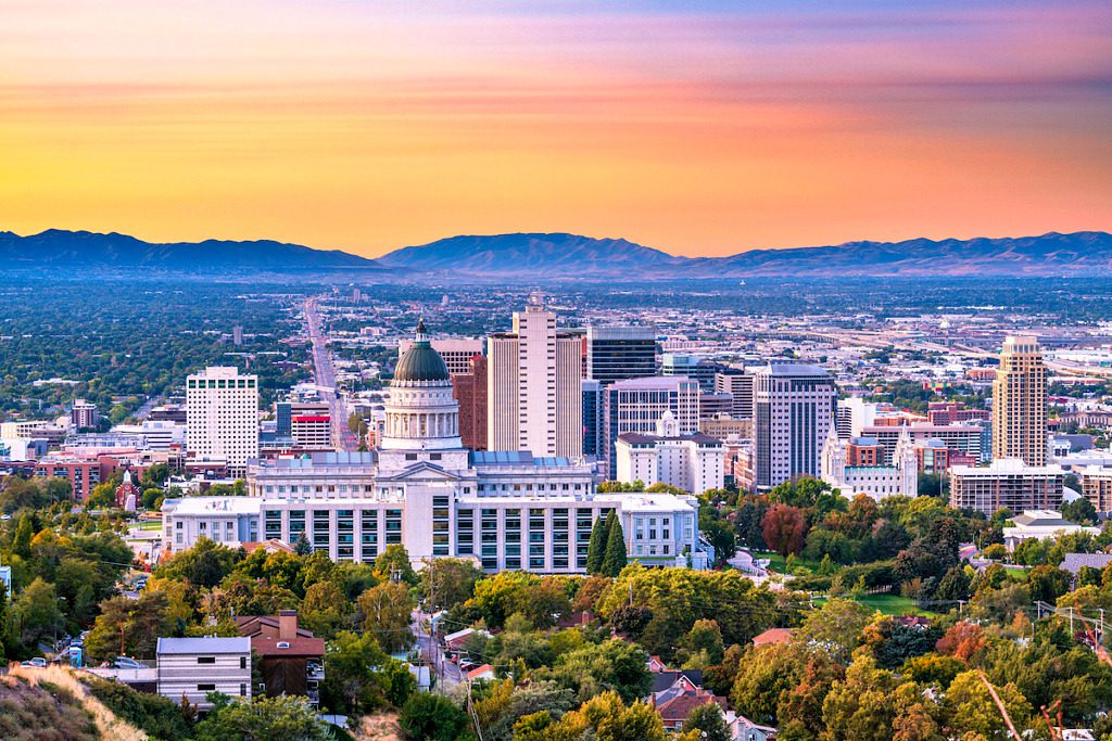 Salt Lake City skyline and Utah State Capitol surrounded by neighborhood streets at sunset
